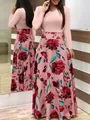 Detail view of a long sleeve floral print maxi dress featuring a pink top and swing skirt - S / Dresses / Pink