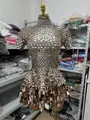 Detailed close-up view of a sparkly gold sequin party dress displayed on a mannequin - Dresses / Gold