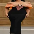 Elegante vestido de noche negro con hombros descubiertos y detalles de lentejuelas naranja - S / Vestidos / Borde Naranja