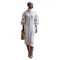 Detailed view of pom-pom and cable knit texture on a cozy winter high-neck dress - S / Dresses / Off White