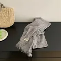 Detailed view of gray pleated cotton linen scarf with elegant fringe edges - Gray
