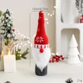 Red knitted Christmas wine bottle cover with gnome beard and snowflake patterns. - Snowflake Rudolph Style