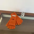 Detailed shot of orange 100% wool flip-top gloves with functional fingerless design - Solid Color Flip Top / Emma Orange
