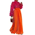 Close-up showing the elegant pleated texture of this orange silk-like maxi skirt for women - S / Bottoms / Orange