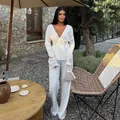 Elegant white pleated long sleeve top and wide-leg pants set shown in an outdoor courtyard - S / Top And Bottom / White