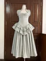 Detailed view of an elegant sage green tiered maxi dress with fishbone corset waist. - Grey Blue