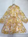 Detailed full-length shot of a yellow floral dress featuring puff sleeves and a waist tie - S / Dresses / Yellow Short Style