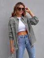 Detailed close-up of a grey oversized denim jacket featuring distressed frayed edges - Light Gray