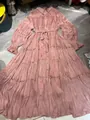 Detailed view of dusty pink pleated tiered maxi dress with button-up collar and waist tie - Pink