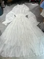 Detailed view of white pleated silky maxi dress with elegant shirt collar design - S / Dresses / White