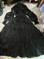 Close-up detail of black pleated mercerized maxi dress featuring a layered tiered skirt - S / Dresses / Black