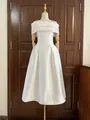 Elegante witte midi-jurk met blote schouders en een getailleerde taille op een etalagepop - S / Wit