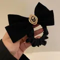 Elegant black velvet scrunchie featuring a vintage rose and pearl embellishment bow - Black Rose Hair Tie / Black