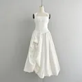 Elegant white halter neck midi dress featuring a slim waist and voluminous pleated skirt - White