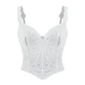 Vista dettagliata di un corsetto bianco in pizzo vintage francese con motivi floreali. - Taglia S / Top / Bianco