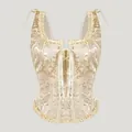 Dettaglio di un corsetto jacquard champagne vintage con elegante design stringato - Taglia S / Top / Bianco avorio