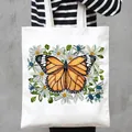 Fashionable white canvas tote bag featuring a vibrant monarch butterfly and floral print - Monarch Butterfly and Daisy Style (15)