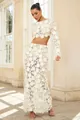 Elegant white floral lace two-piece set shown in full length architectural setting - S / Top And Bottom / White