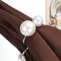 Elegant silver napkin ring decorated with two white pearls on a brown fabric napkin - Silver Pearl Style (C57) / Silver