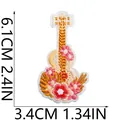 Close-up view of a floral guitar embroidery patch showing 6.1cm by 3.4cm dimensions - Floral Guitar Style (X11BM-086-36)