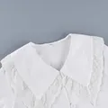 Detailed macro shot of white French cotton blouse with elegant lace Peter Pan collar - S / Tops / White