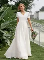 Full-length view of a white lace and chiffon V-neck wedding dress in a garden - S / Dresses / White
