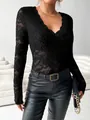 Detailed view of elegant black lace long-sleeve top featuring a scallop V-neckline - S / Tops / Black
