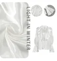 Macro detail of elegant white satin blouse with ruffled collar and glossy fabric texture - S / Tops / White
