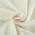 Macro detail of high-quality cream satin fabric showing smooth texture and soft luster - S / Tops / Beige