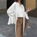 Elegant white satin pussy-bow blouse for women featuring stylish ruffle flare bell sleeves - S / Tops / Beige