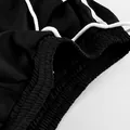 Détail de la taille élastique et du cordon blanc sur un pantalon à rayures. - S / Bas / Noir