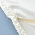 Macro detail of high-quality invisible zipper on elegant cream satin camisole top - S / Tops / Apricot