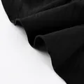 Close-up of the black ruffled hem and delicate stitching on a tiered skirt fabric. - S / Black