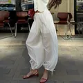 Elegant loose white drawstring semi-transparent trousers featuring chic elasticated cuffs - S / Bottoms / White Striped