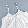 Close-up of a white V-neck camisole dress with adjustable straps and soft cotton texture - S / Dresses / White