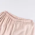 Close-up of shimmering casual pants with elastic waistband and silky fabric texture - S / Bottoms / Champagne
