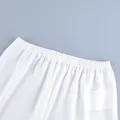 Close-up detail of the comfortable elastic waistband on white casual straight-leg pants - S / Bottoms / White