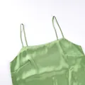 Detail shot showing the glossy satin fabric and thin straps of a green camisole top - S / Tops / Weight M: 190G