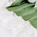 Macro shot of the delicate white floral lace trim on sage green garment fabric set - S / Tops / 94% Polyester 6% Spandex
