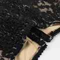 Macro detail of black floral lace fabric with hook-and-eye closure and beige lining. - S / Tops / Black