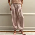Elegant champagne pink satin lantern pants featuring a loose fit and elastic waist design - S / Pink