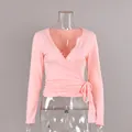 Detailed view of pink V-neck long sleeve wrap top with side tie for yoga and Pilates. - S / Tops / Pink