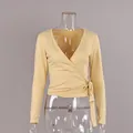 Elegant pale yellow V-neck wrap long sleeve top with side-tie detail on mannequin - S / Tops / Khaki