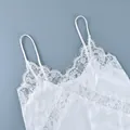Detailed view of elegant white floral lace patchwork on a satin camisole strap top - S / Tops / White