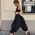 Detailed side view of chic black balloon pants captured in a stylish street fashion setting - S / Bottoms / Black