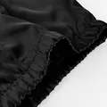 Close-up of the elastic waistband on these smooth black satin-look trousers for women - S / Bottoms / Black