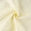 Macro view showing the elegant light cream pleated fabric texture of the lantern pants. - S / Bottoms / Beige