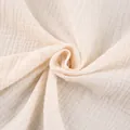 Macro detail of soft beige pure cotton gauze fabric with natural crinkle texture. - S / Dresses / White