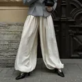 Elegant cream loose lantern pants featuring textured fabric and cuffed hem for a casual chic look - S / Bottoms / Beige