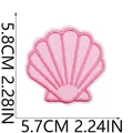 Detailed macro shot of a pink seashell embroidered iron-on patch with dimensions. - Pink Scallop (W29PX-09-02)
